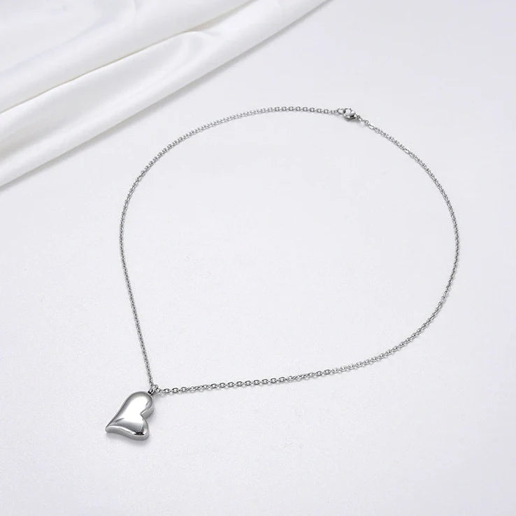 Silver curved peach heart pendant on stainless steel chain with adjustable length