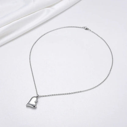 Silver curved peach heart pendant on stainless steel chain with adjustable length