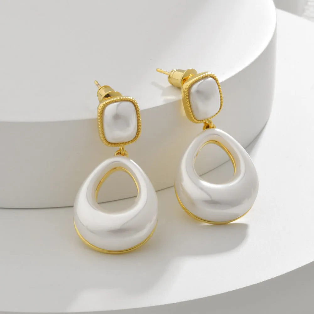 Gold-plated mabe pearl drop earrings with imitation pearl drops and office-appropriate styling