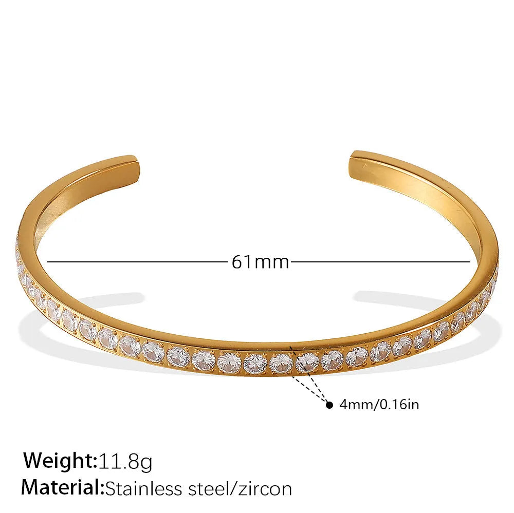 Stainless steel open-end bracelet with a buckle clasp in a gold electroplated finish featuring circle design elements.