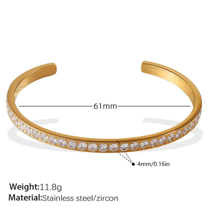 Stainless steel open-end bracelet with a buckle clasp in a gold electroplated finish featuring circle design elements.