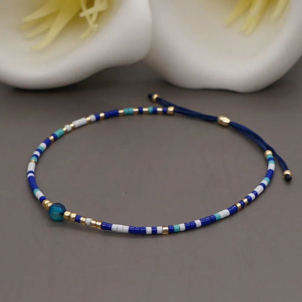 Handmade women's bracelet with colourful geometric glass and coloured glaze beads in Bohemian style.