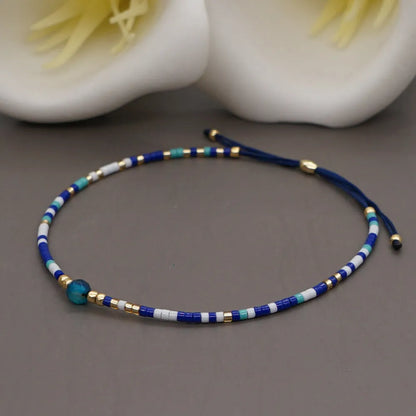Handmade women's bracelet with colourful geometric glass and coloured glaze beads in Bohemian style.