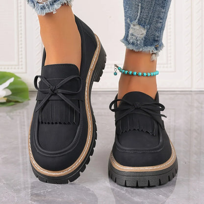 Women's black plus size loafers with tassel, bowknot, chunky heel, and rubber sole