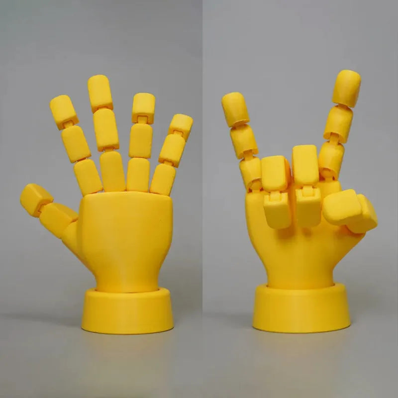 Yellow movable joint hand ornament showing articulated fingers and wrist joints