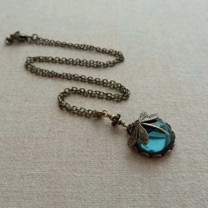 Vintage bronze dragonfly pendant necklace on a chain, yellow finish, pastoral style.