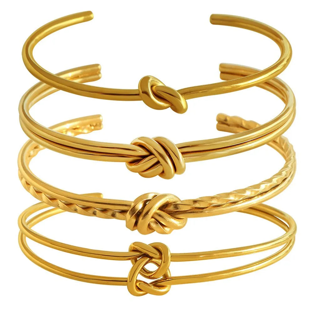 Women's knotted C-shaped open double-layer stainless steel bracelet with gold plating.