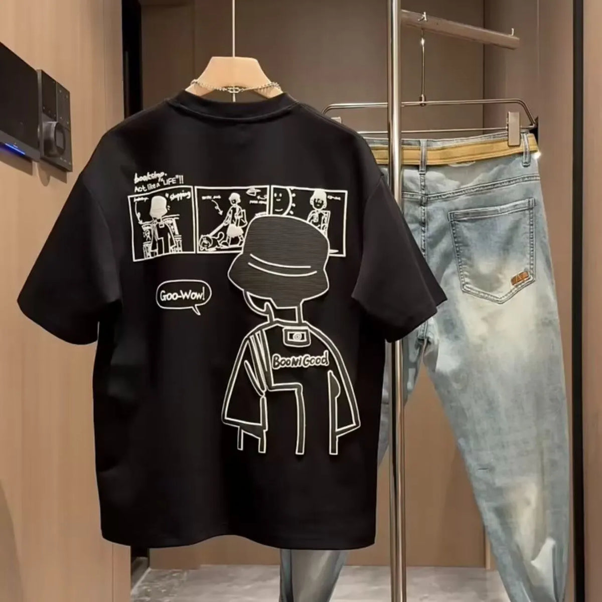 Men's black cotton short sleeve t-shirt with a cartoon print, showing crew neck and straight cut.