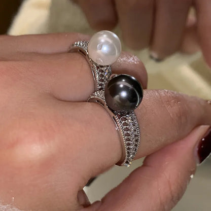 Black Pearl geometric open-ended adjustable copper ring on a woman's finger, showing angular design.