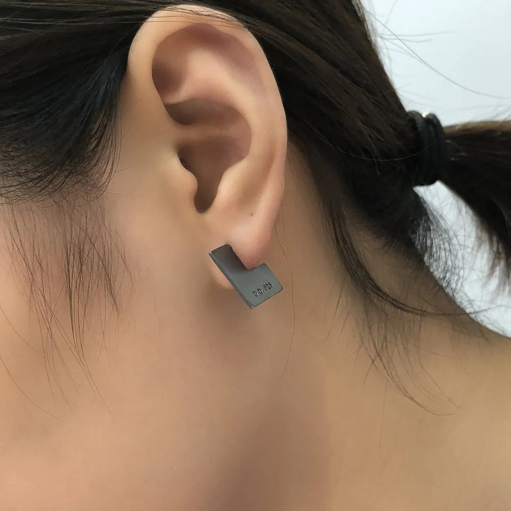 Oxidised black sterling silver earrings with a geometric square shape and minimalist ring design.
