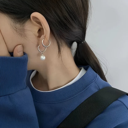 Geometric round pearl drop earrings for women with alloy metal and titanium steel posts.