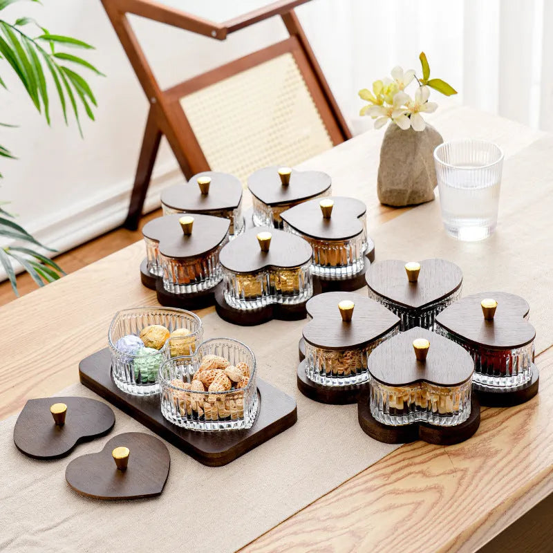 Glass dim sum fruit platter with coloured glaze and a transparent heart-shaped lid on a multi-grid tray.