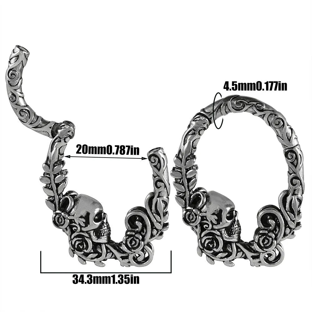 A pair of stainless steel fashion earrings featuring a totem pattern design in an electroplated colour.