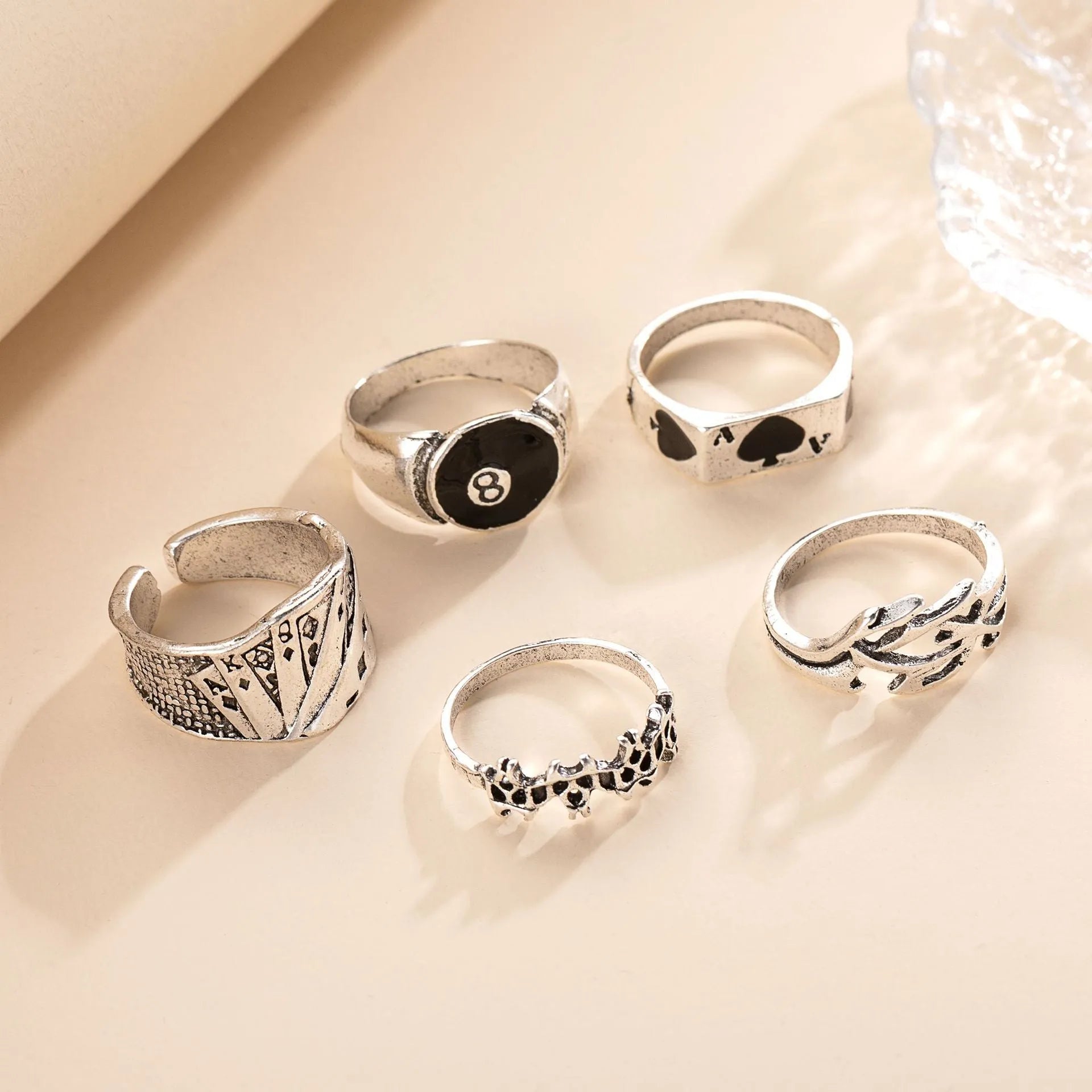 Adjustable black alloy ring with a large raised poker spade motif on a finger.