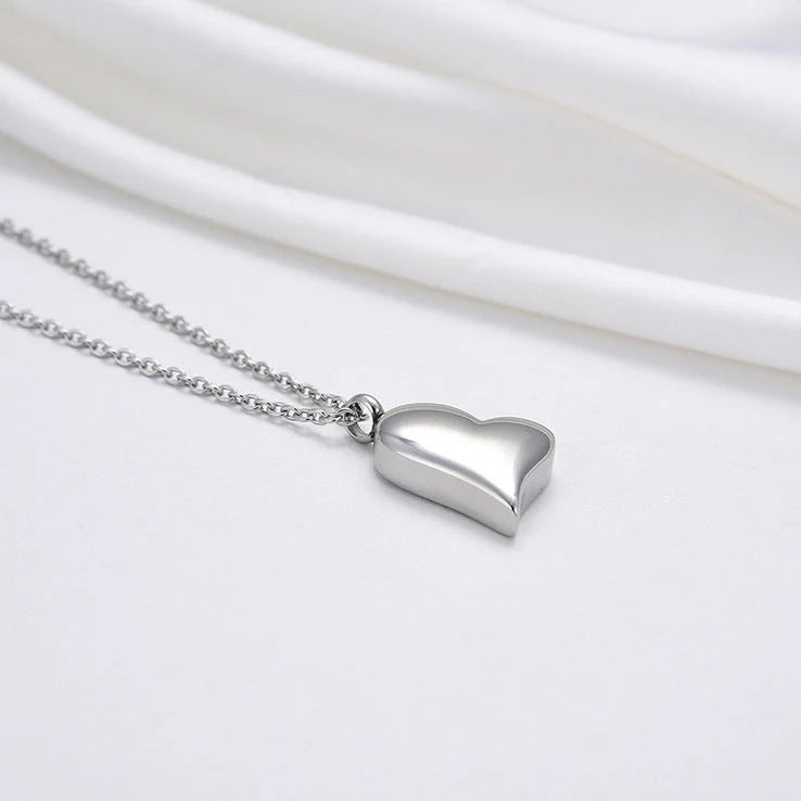 Silver curved peach heart pendant on stainless steel chain with adjustable length