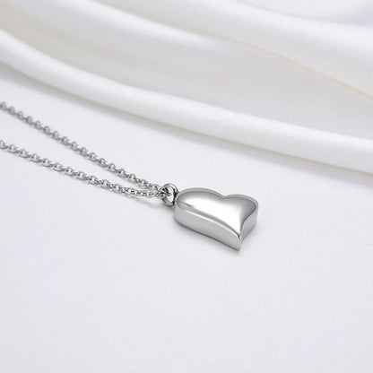 Silver curved peach heart pendant on stainless steel chain with adjustable length