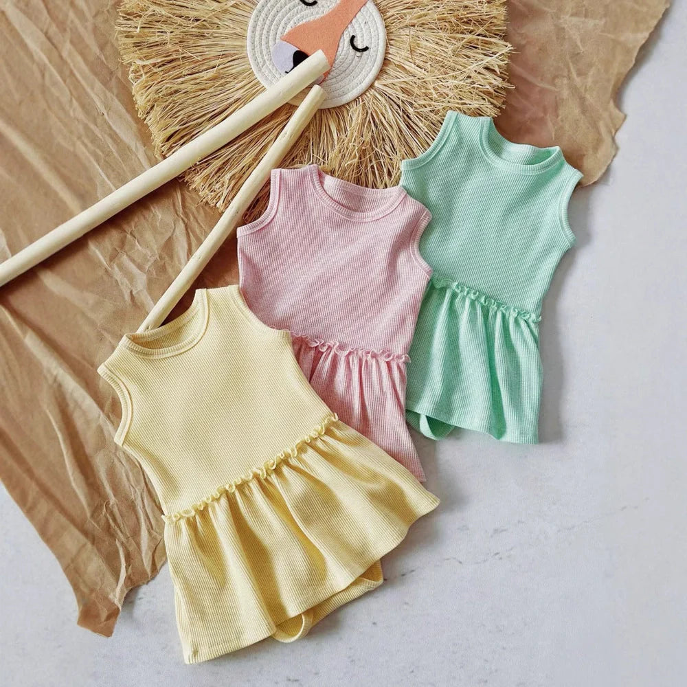 Baby girl wearing pink sleeveless vest onesie with waffle cotton texture and single-breasted closure