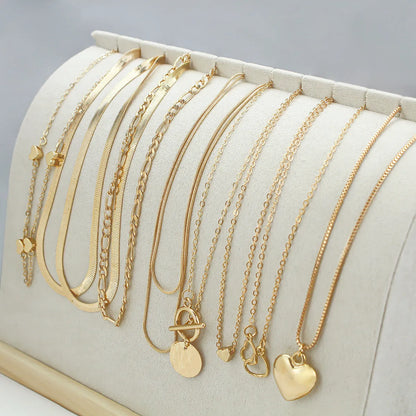 10 gold necklaces with adjustable chains from 21cm to 50cm, featuring electroplated alloy pendants on snake bone chains