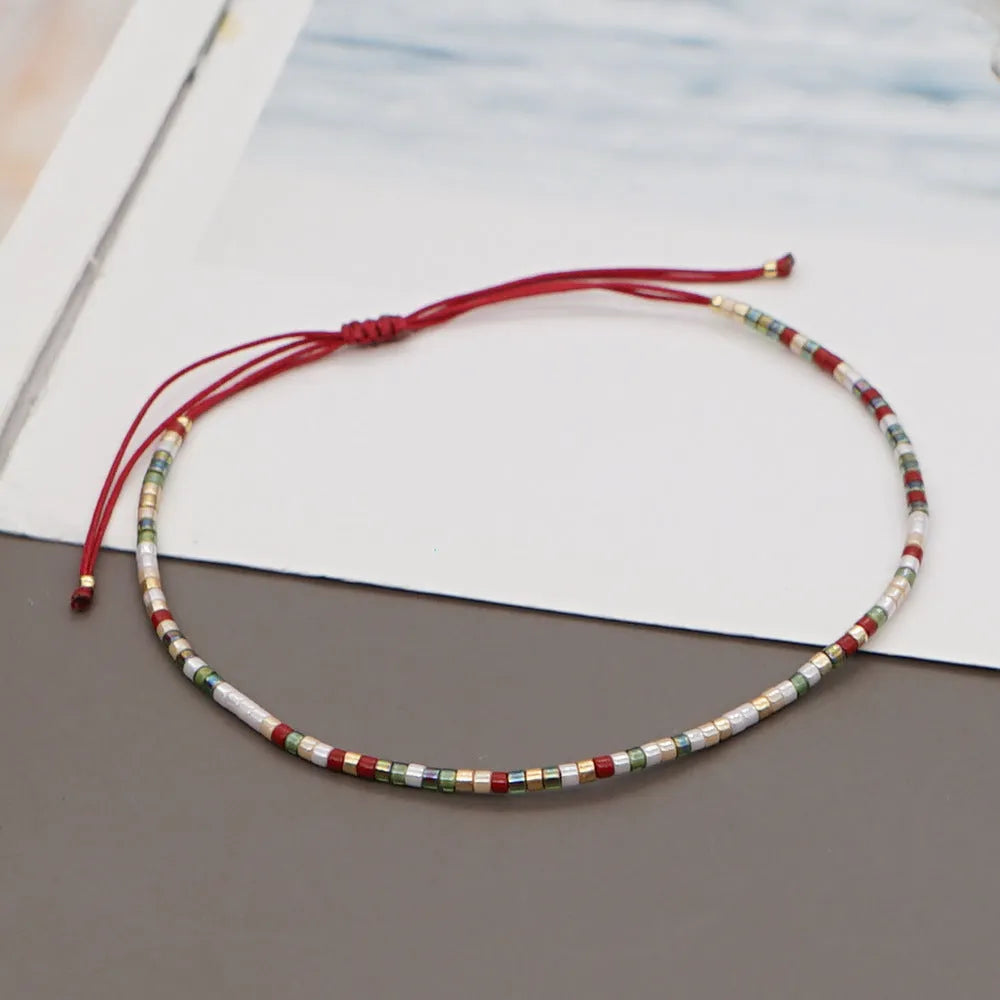 Handmade women's bracelet with colourful geometric glass and coloured glaze beads in Bohemian style.