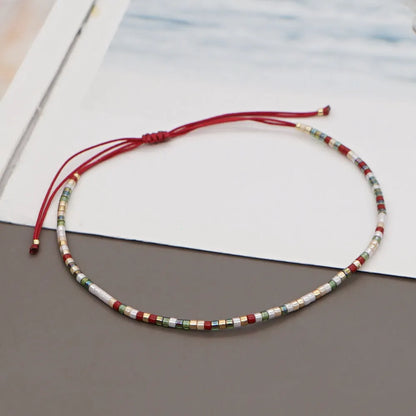 Handmade women's bracelet with colourful geometric glass and coloured glaze beads in Bohemian style.