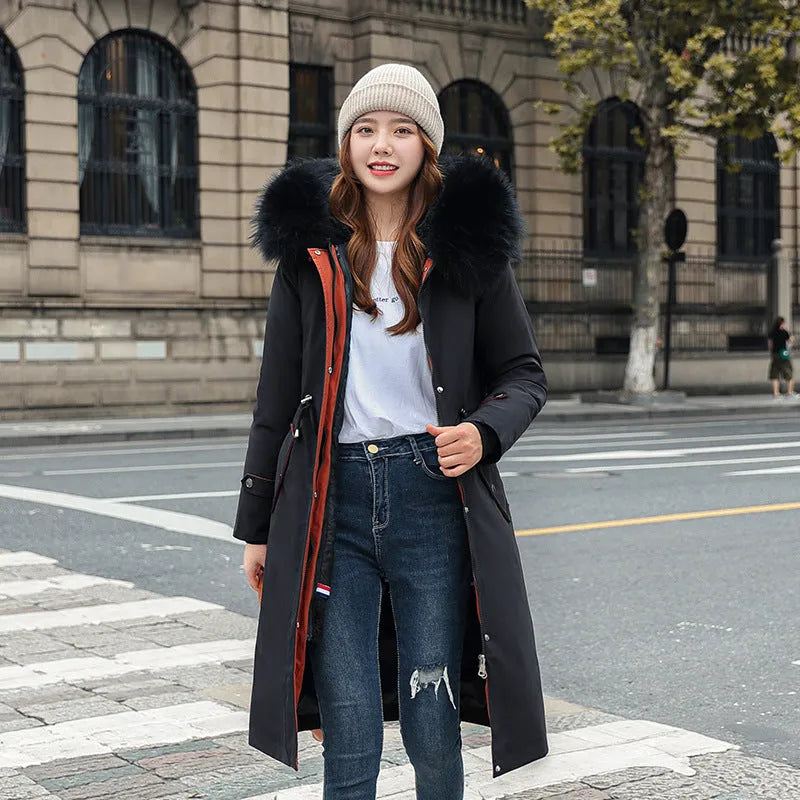 Long white women's fleece trench coat with down cotton padding on a hanger.