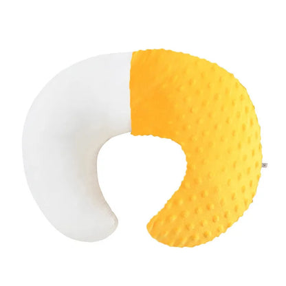 Nursing pillow with integrated 15cm raised barrier to prevent milk spills during breastfeeding, shown with removable pillowcase