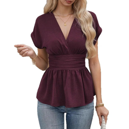 Women's solid colour polyester V-neck top with waist pleating and short sleeves.