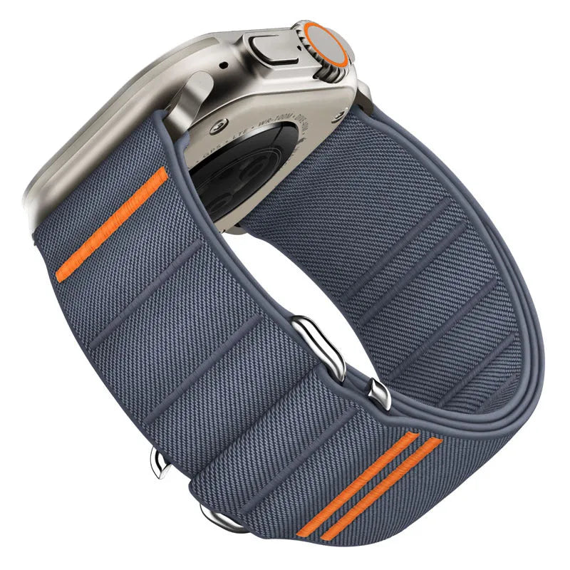 Elastic nylon Apple Watch band in Army Green with stainless steel buckle, shown on a wrist.