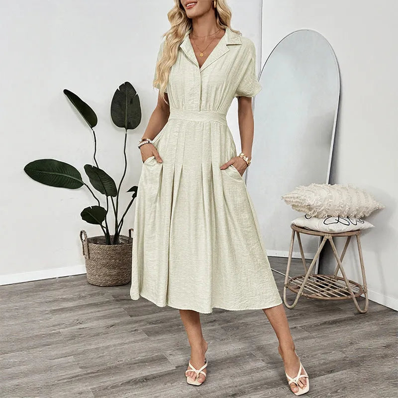 Light green women's shirt dress with lapel collar, waist tie, and pockets on a mannequin.