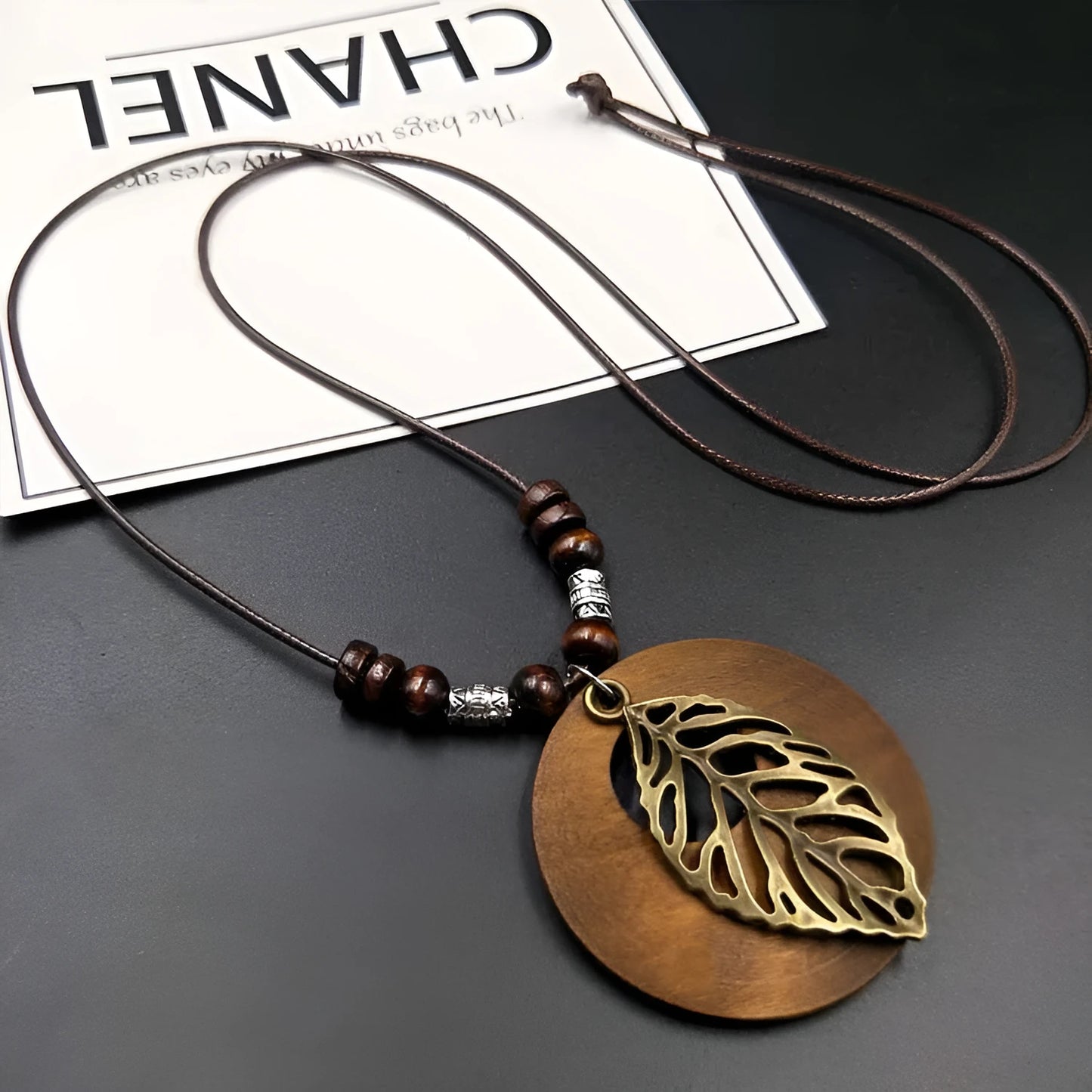 Adjustable wooden and electroplated leaf pendant necklace on wax cord chain
