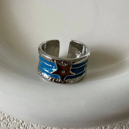 Geometric drop oil women's ring with adjustable band in distressed electroplated finish.