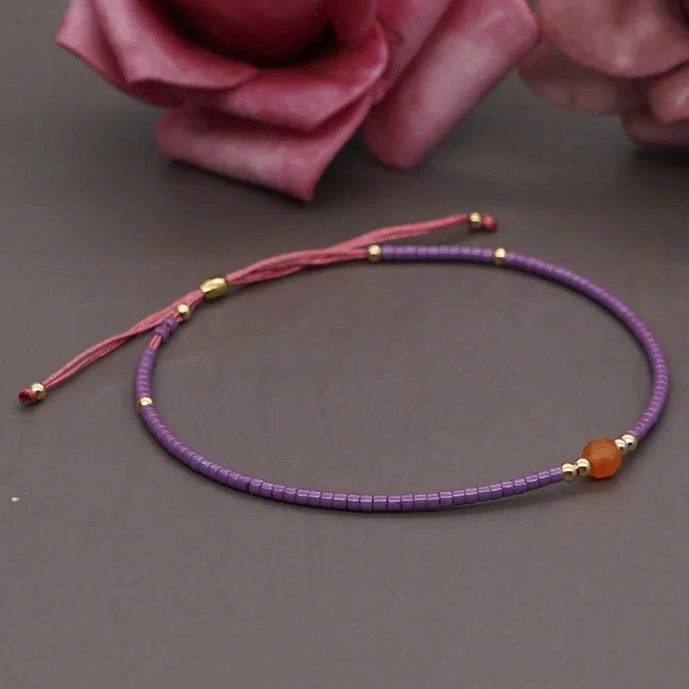 Handmade women's bracelet with colourful geometric glass and coloured glaze beads in Bohemian style.