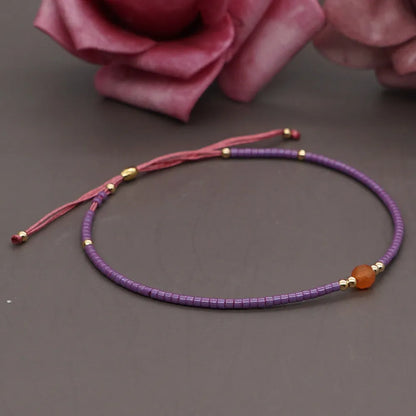 Handmade women's bracelet with colourful geometric glass and coloured glaze beads in Bohemian style.