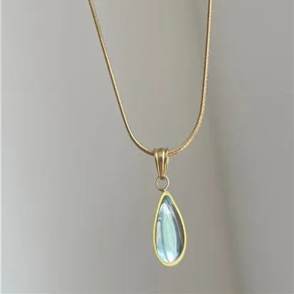 Retro style blue water drop titanium steel pendant necklace with snake bone chain on a white background.