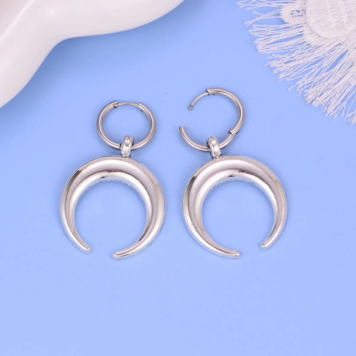 Silver big hoop earrings with a gothic moon and geometric punk design, ear clip style.