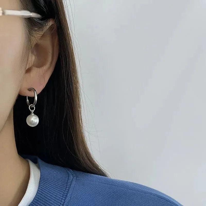 Geometric round pearl drop earrings for women with alloy metal and titanium steel posts.