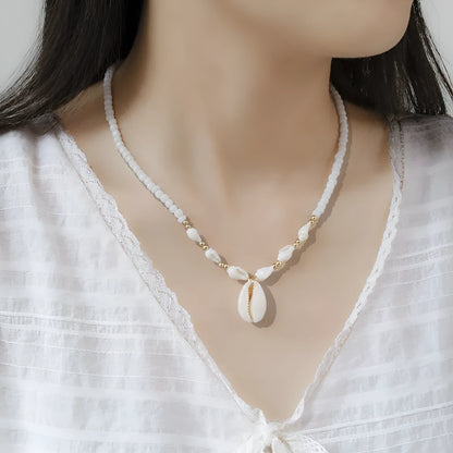 White shell necklace with conch pendant on 45cm chain, electroplated finish.