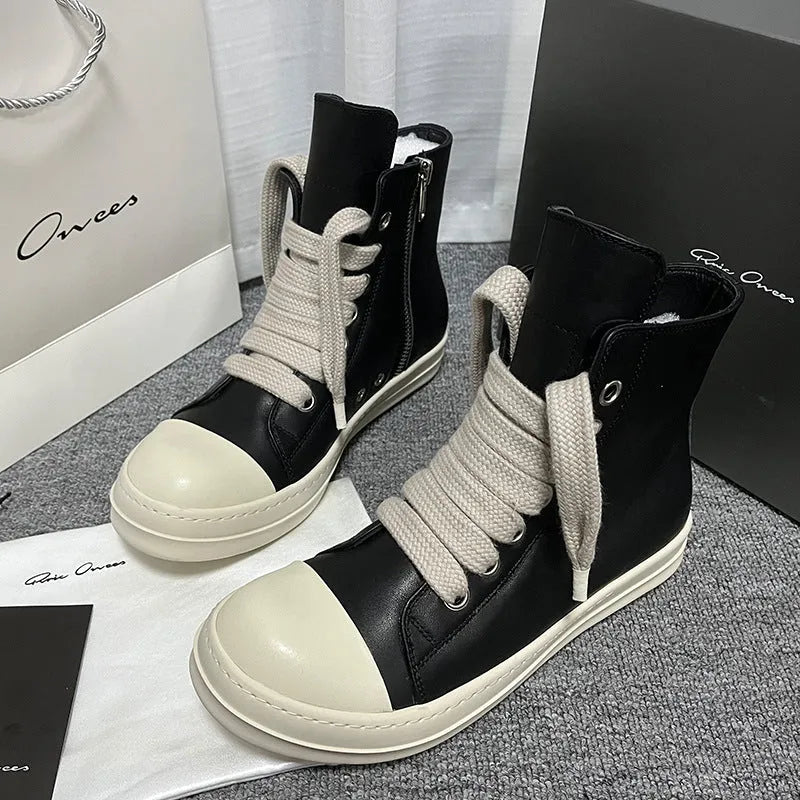 Black high-top leather sneakers with side zipper, round toe, and stitching details on genuine cowhide upper