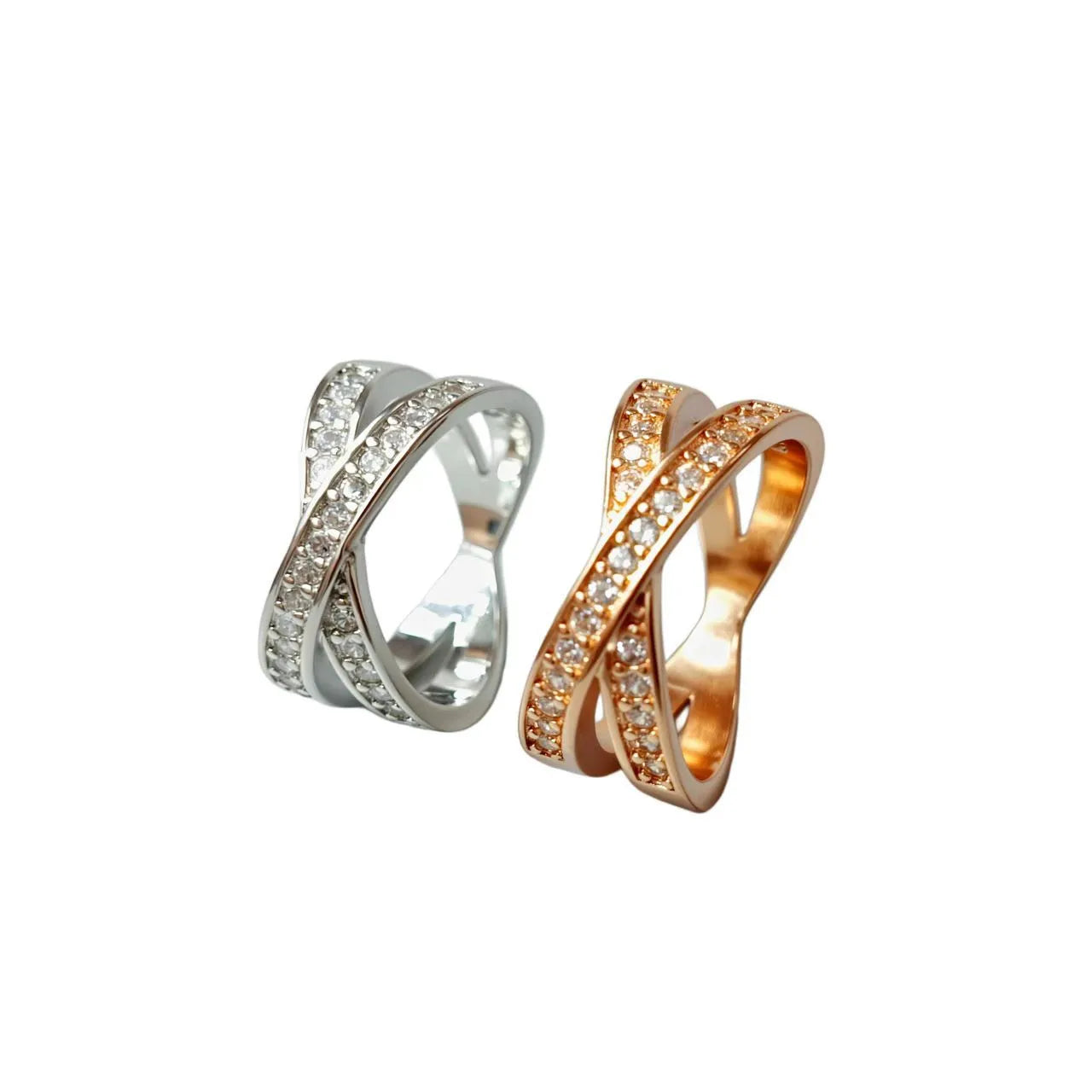 Silver geometric cross ring with micro-inlaid zircon stones on finger, showing simple design with heart-shaped elements