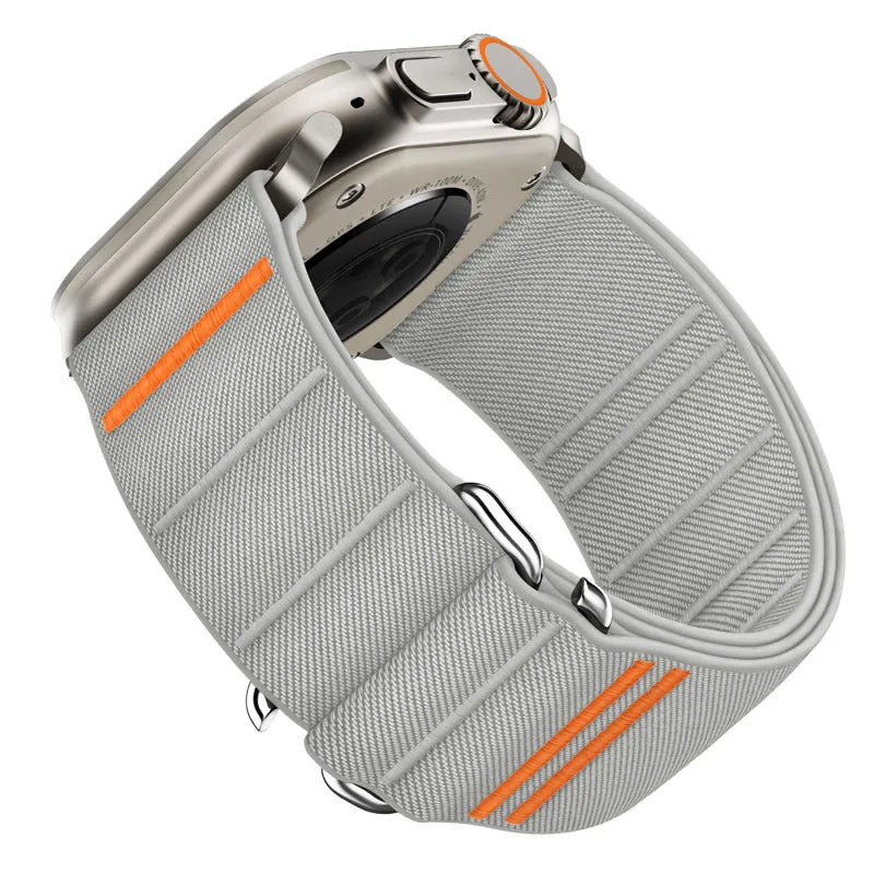 Elastic nylon Apple Watch band in Army Green with stainless steel buckle, shown on a wrist.