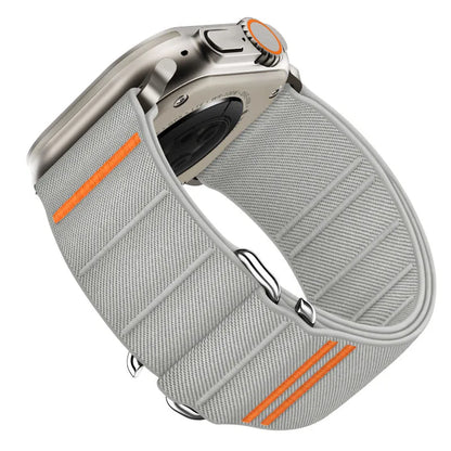 Elastic nylon Apple Watch band in Army Green with stainless steel buckle, shown on a wrist.