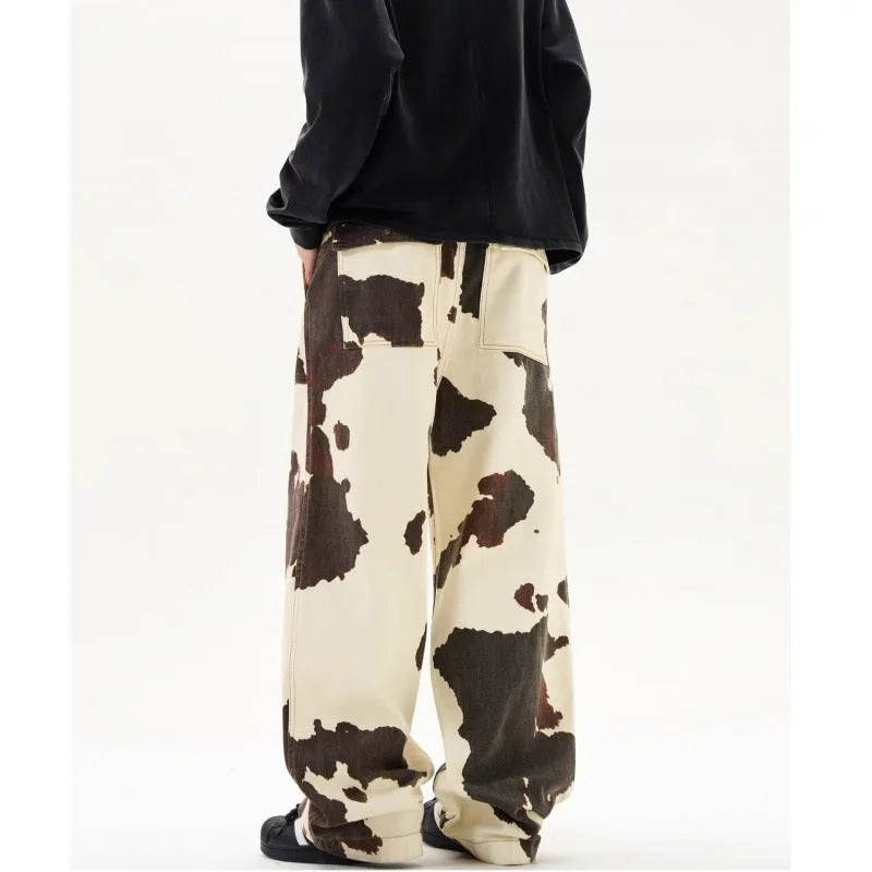 Men's straight-leg trousers with a brown and white cow pattern print.