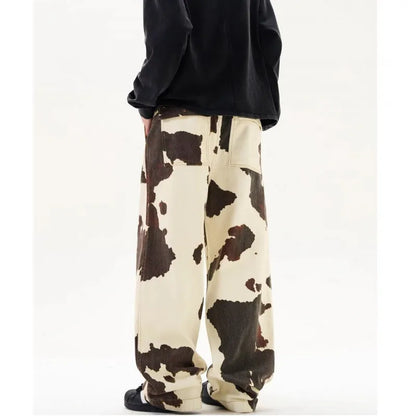 Men's straight-leg trousers with a brown and white cow pattern print.