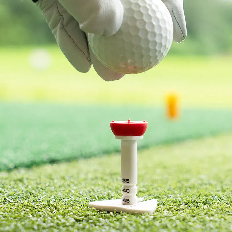 Golf tee ball nail holder in silicone reinforced plastic with aiming direction marker, shown in red, green, blue, or orange