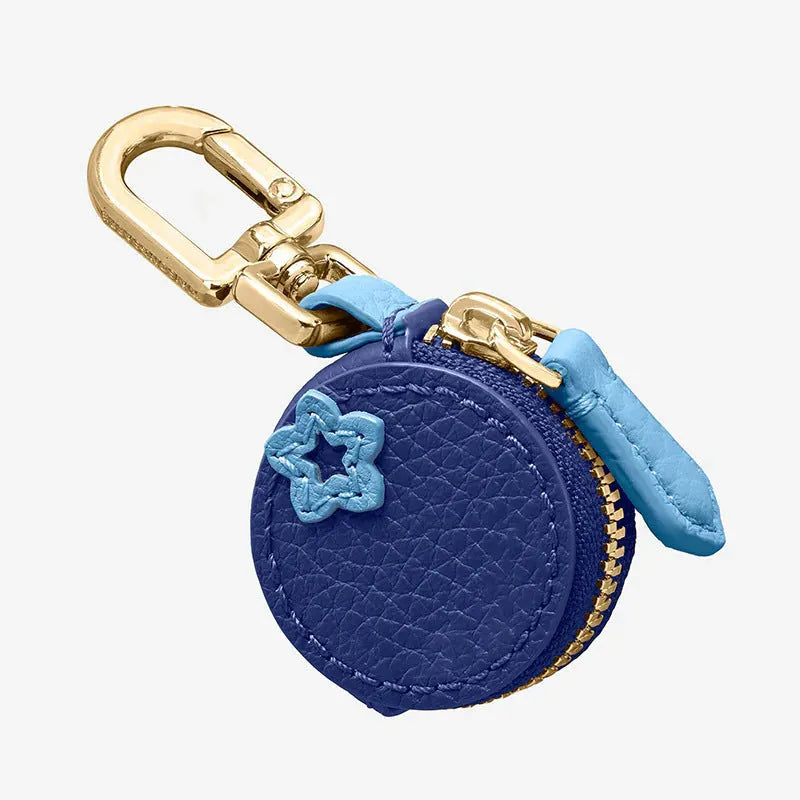 Small solid colour PU leather keychain coin bag in cherry, blueberry, or orange.