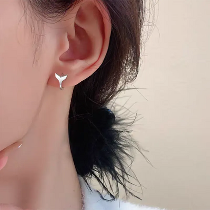 A pair of women's simple fishtail drop earrings with a gold electroplated finish on a copper base.