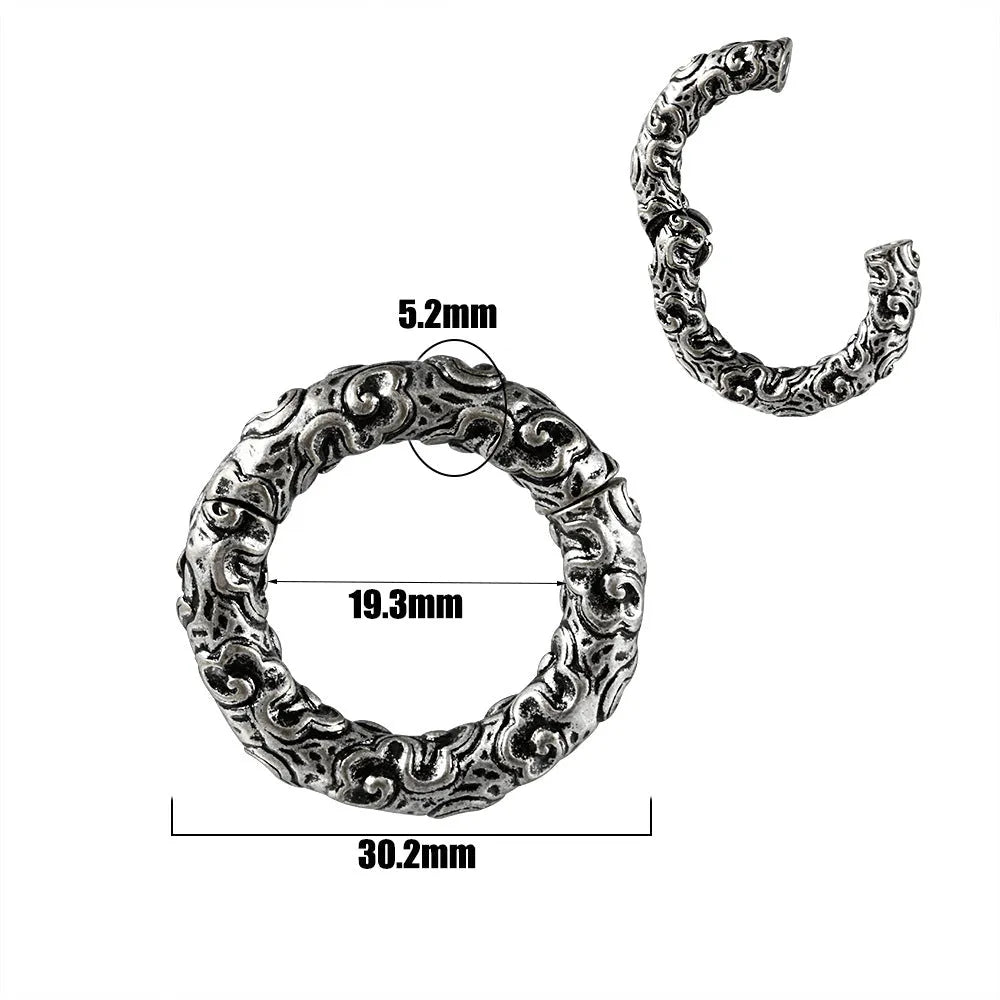 A pair of stainless steel fashion earrings featuring a totem pattern design in an electroplated colour.