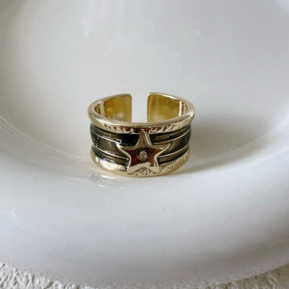 Geometric drop oil women's ring with adjustable band in distressed electroplated finish.