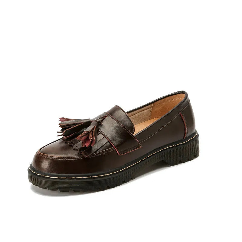 Women's brown leather loafers with tassel detail and a chunky low heel.
