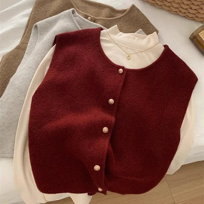 Women's thin knit half-sleeve pullover jumper in Angora red, laid flat.